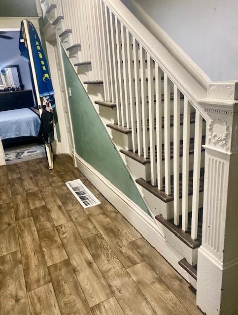 staircase with wood-type flooring