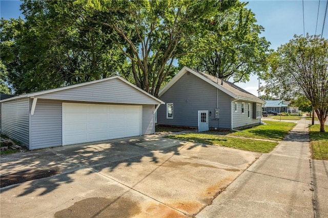 view of side of home with a garage and an outdoor structure