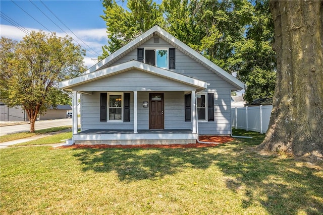 bungalow with a porch and a front lawn