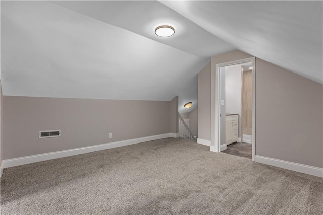 bonus room featuring lofted ceiling and carpet flooring