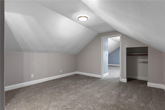 additional living space with lofted ceiling and dark carpet