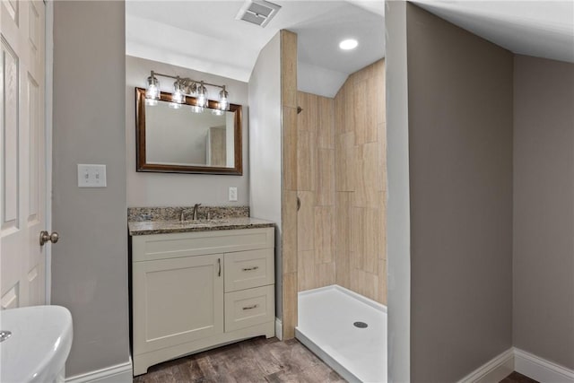 bathroom with a shower, vanity, and hardwood / wood-style flooring