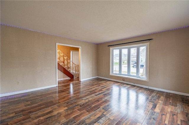 unfurnished room with dark hardwood / wood-style floors