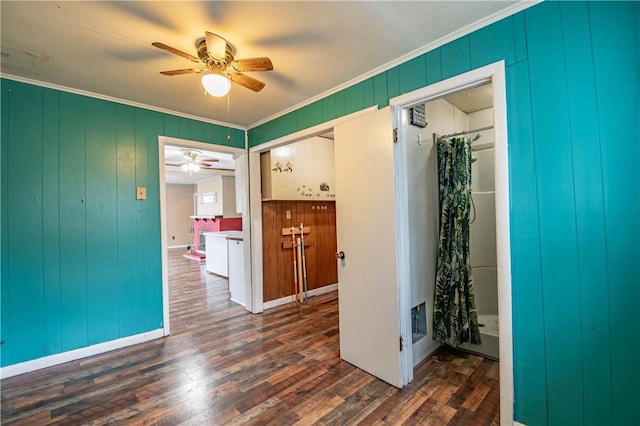 interior space with ceiling fan, dark hardwood / wood-style flooring, and crown molding