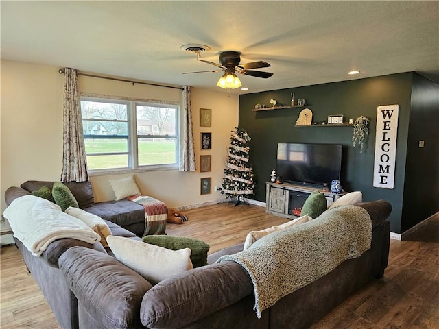 living room featuring ceiling fan and wood-type flooring