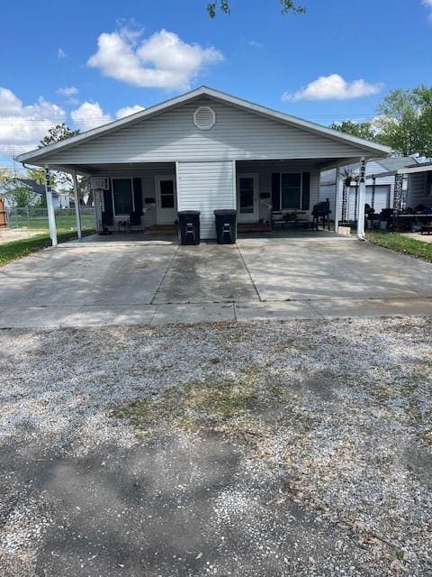 view of front of house featuring concrete driveway and a carport