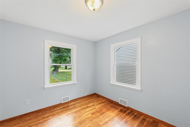 1609 10th St, Charleston, IL 61920 - spare room featuring light wood-style flooring and baseboards