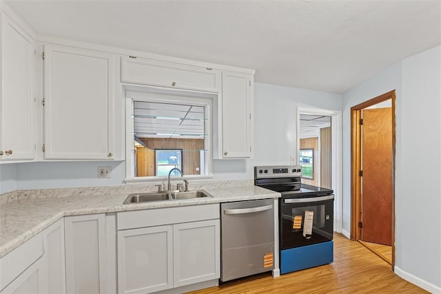1609 10th St, Charleston, IL 61920 - kitchen with stainless steel dishwasher, electric stove, white cabinets, and light wood-style floors