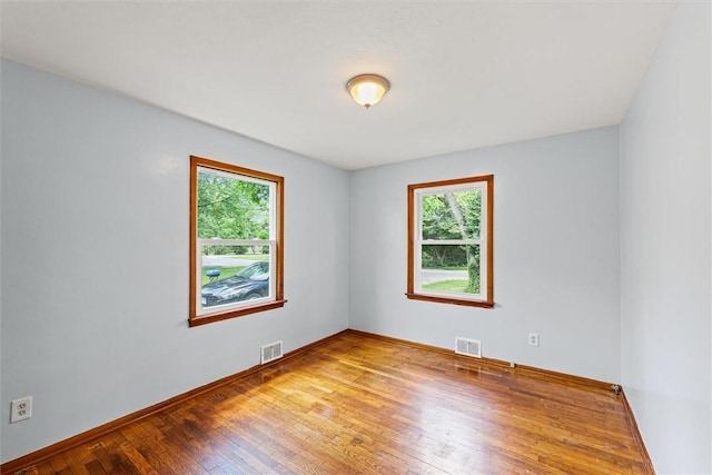 1609 10th St, Charleston, IL 61920 - unfurnished room with plenty of natural light and hardwood / wood-style flooring
