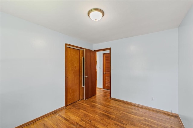 1609 10th St, Charleston, IL 61920 - empty room featuring wood finished floors and baseboards