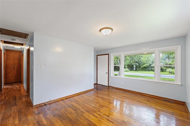 1609 10th St, Charleston, IL 61920 - unfurnished room with baseboards and hardwood / wood-style flooring