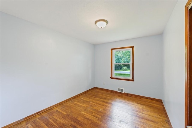 1609 10th St, Charleston, IL 61920 - empty room featuring hardwood / wood-style floors and baseboards