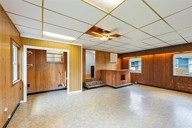 1609 10th St, Charleston, IL 61920 - unfurnished living room with wooden walls, tile patterned floors, and ceiling fan