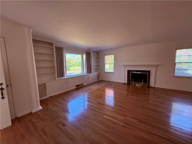 unfurnished living room featuring dark hardwood / wood-style flooring