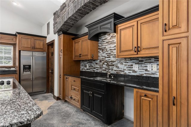 2098 2070th Ave, Saint Elmo, IL 62458 - kitchen with stainless steel refrigerator with ice dispenser, backsplash, lofted ceiling, brown cabinets, and dark stone countertops