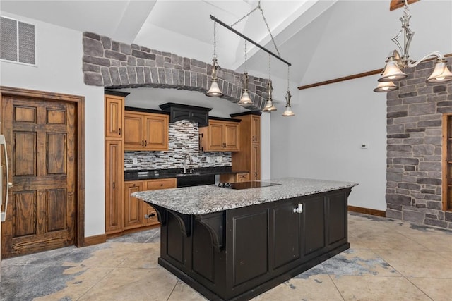 2098 2070th Ave, Saint Elmo, IL 62458 - kitchen featuring a kitchen island, black electric stovetop, backsplash, brown cabinetry, and pendant lighting