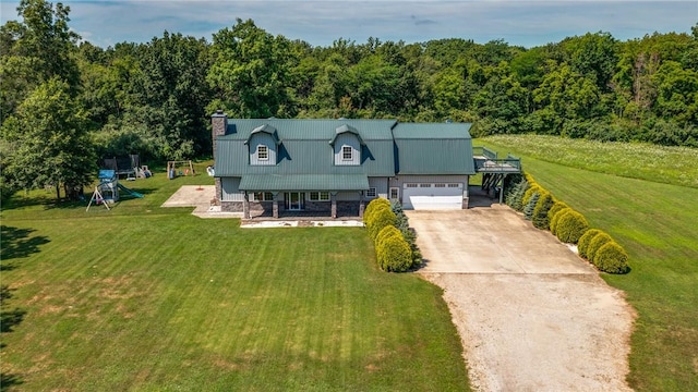 2098 2070th Ave, Saint Elmo, IL 62458 - view of front facade featuring driveway, a chimney, a front lawn, an attached garage, and a wooded view