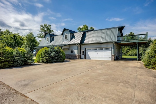 2098 2070th Ave, Saint Elmo, IL 62458 - view of side of home featuring driveway, a metal roof, stone siding, board and batten siding, and a deck