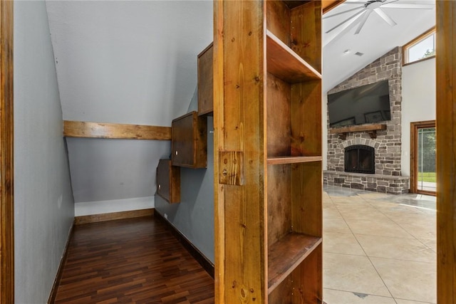 2098 2070th Ave, Saint Elmo, IL 62458 - stairs with lofted ceiling, a ceiling fan, plenty of natural light, a stone fireplace, and wood finished floors