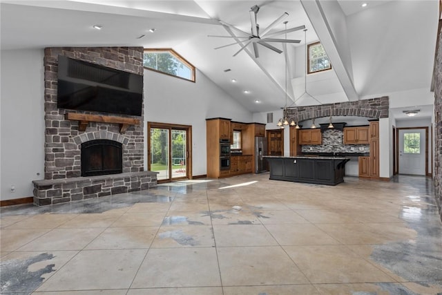 2098 2070th Ave, Saint Elmo, IL 62458 - unfurnished living room with high vaulted ceiling, ceiling fan, a stone fireplace, plenty of natural light, and light tile patterned floors