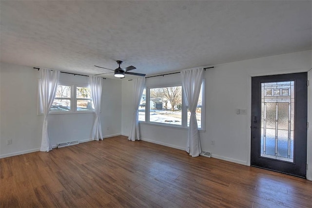 interior space with hardwood / wood-style flooring, a wealth of natural light, a textured ceiling, and ceiling fan