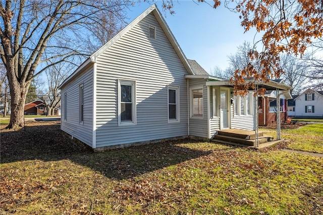 rear view of property featuring a yard