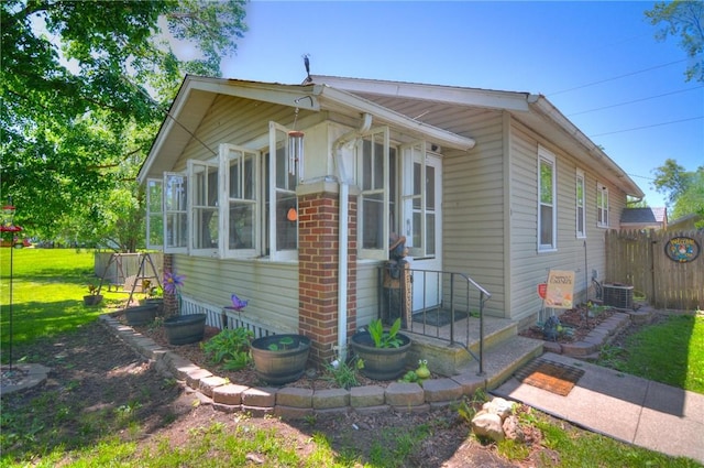 805 N 33rd St, Decatur, IL 62521 - view of front of property with central AC and a sunroom