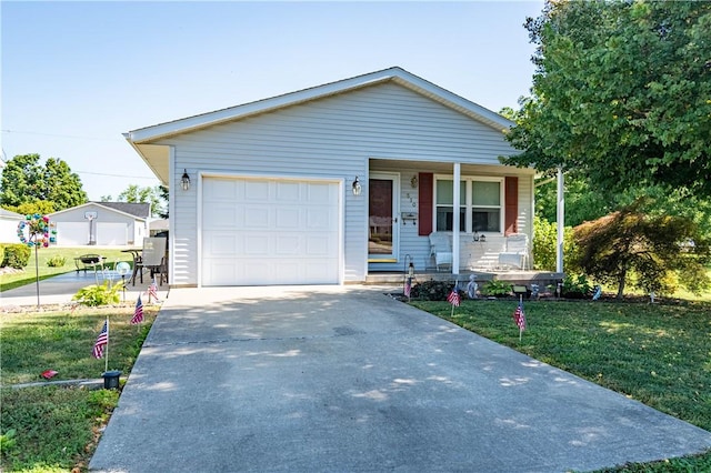 510 W Illinois St, Assumption, IL 62510 - view of front of home with covered porch, driveway, a front yard, and a garage