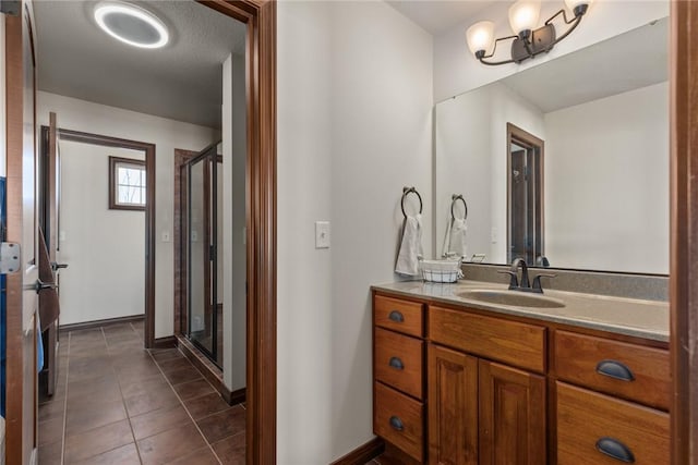 bathroom featuring vanity, tile patterned flooring, and an enclosed shower