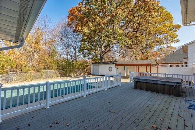 wooden deck featuring a hot tub