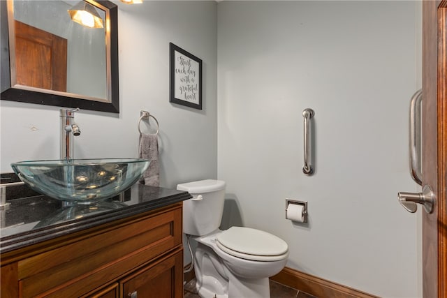 bathroom featuring toilet, vanity, and tile patterned floors