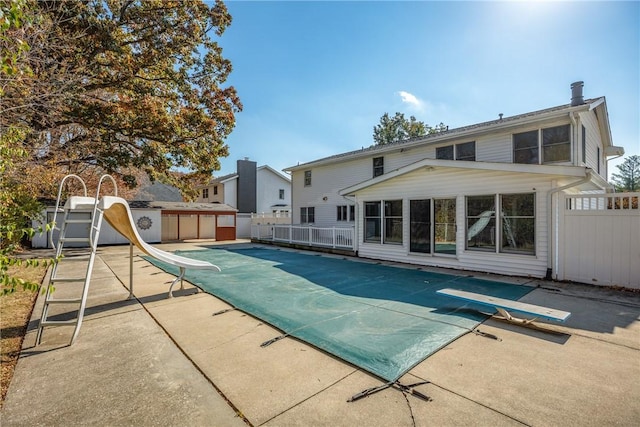 1025 Cardinal Dr, Effingham, IL 62401 - view of swimming pool featuring a water slide, a diving board, and a patio area