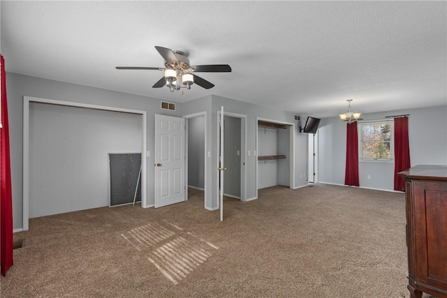 1025 Cardinal Dr, Effingham, IL 62401 - unfurnished living room featuring carpet floors, a chandelier, and a ceiling fan