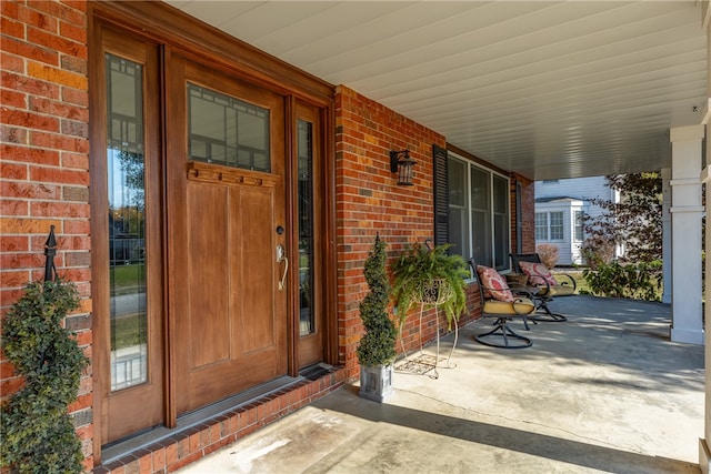 view of exterior entry featuring a porch