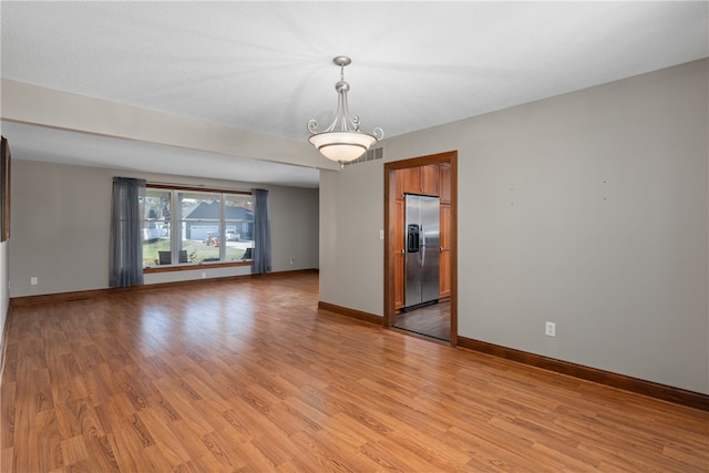 spare room with light hardwood / wood-style floors