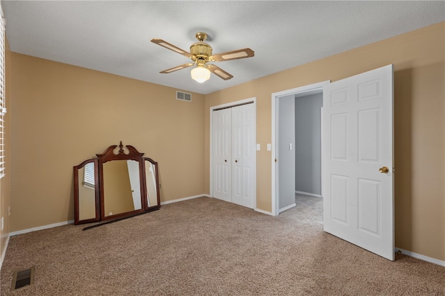 unfurnished bedroom featuring carpet, a closet, and ceiling fan