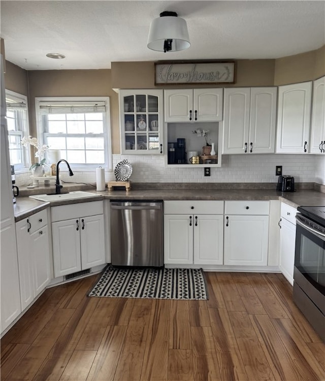 1729 County Road 2300e, Westfield, IL 62474 - kitchen featuring appliances with stainless steel finishes, a sink, white cabinetry, dark wood-type flooring, and backsplash