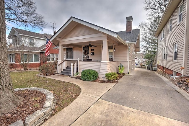 bungalow-style home with covered porch and a front lawn