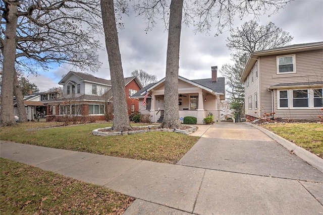 view of front of home with covered porch and a front lawn