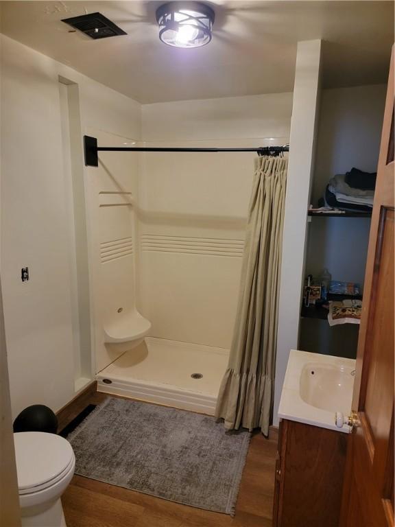 410 E Ninth St, Pana, IL 62557 - full bathroom with a shower stall, wood finished floors, and vanity
