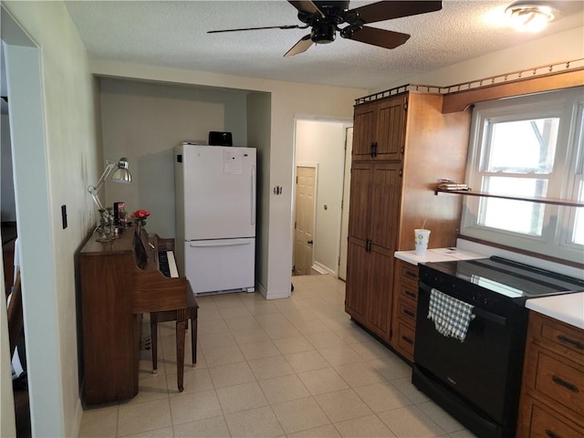410 E Ninth St, Pana, IL 62557 - kitchen featuring freestanding refrigerator, brown cabinets, ceiling fan, a textured ceiling, and light countertops