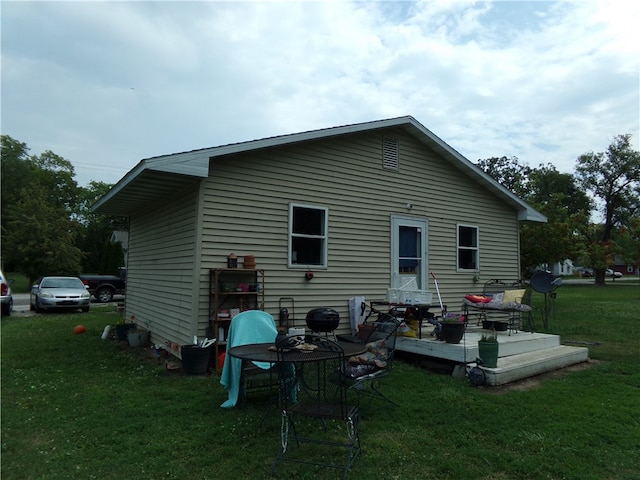 rear view of house featuring a yard