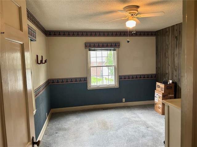 8 Noyes Ct, Mattoon, IL 61938 - empty room featuring ceiling fan, carpet floors, a textured ceiling, and wooden walls