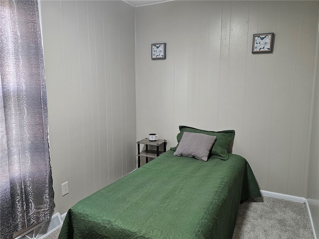 bedroom featuring visible vents, baseboards, and carpet