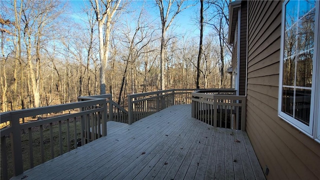 wooden deck with a wooded view