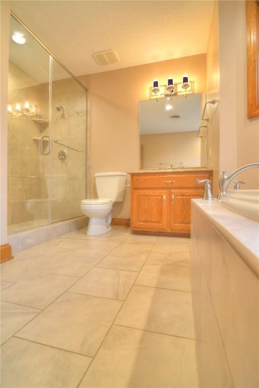 bathroom with toilet, a shower stall, visible vents, and vanity