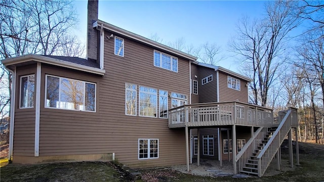 back of property with stairs and a deck