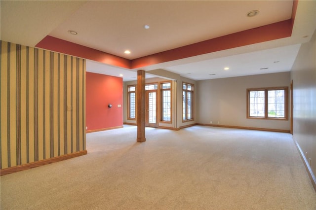 empty room featuring light colored carpet and baseboards