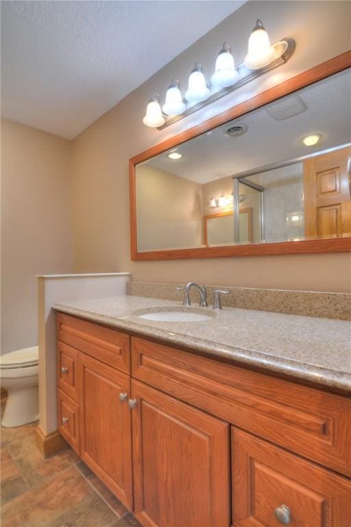 bathroom featuring toilet and vanity