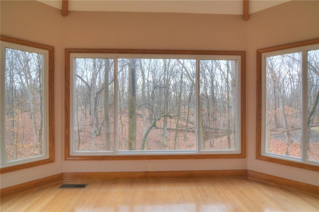 unfurnished sunroom featuring visible vents